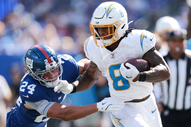 Sep 28, 2025; East Rutherford, New Jersey, USA; Los Angeles Chargers running back Omarion Hampton (8) rushes as New York Giants safety Dane Belton (24) defends during the second quarter at MetLife Stadium. Mandatory Credit: Vincent Carchietta-Imagn Images/ File Photo