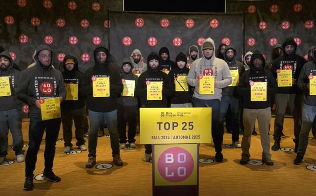 Police officers from across Canada stand on stage wearing life-sized masks depicting fugitives on the BOLO Program’s new Top 25 Most Wanted list, unveiled during a press conference in Vancouver on Oct. 8, 2025. The display, meant to help the public recognize Canada’s most wanted offenders, includes three men wanted in Winnipeg for murder and attempted murder. photo credit: Submitted