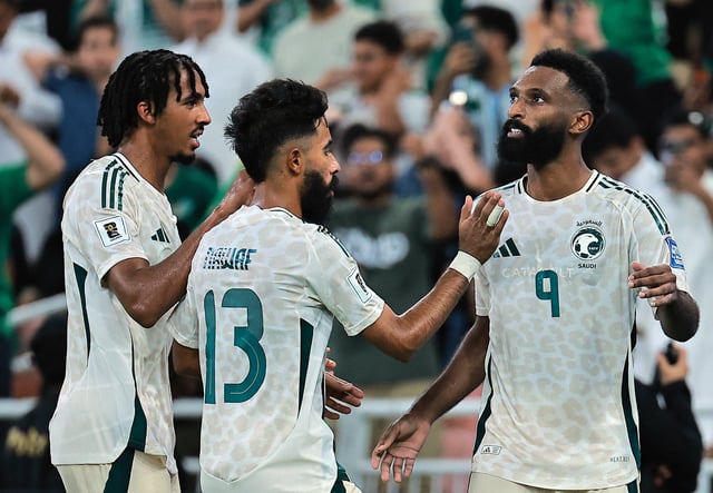 Soccer Football - FIFA World Cup - AFC Qualifiers - Group B - Indonesia v Saudi Arabia - King Abdullah Sports City, Jeddah, Saudi Arabia - October 8, 2025 Saudi Arabia's Feras Al-Brikan celebrates scoring their third goal with Saudi Arabia's Nawaf Boushal and Saudi Arabia's Jehad Thakri REUTERS/Stringer