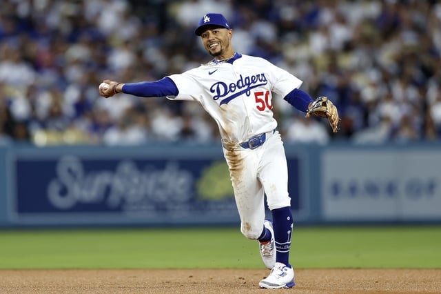 LOS ANGELES, CALIFORNIA - SEPTEMBER 30: Mookie Betts #50 of the Los Angeles Dodgers throws to first base against the Cincinnati Reds during the first inning in game one of the National League Wild Card Series at Dodger Stadium on September 30, 2025 in Los Angeles, California. (Photo by Ronald Martinez/Getty Images)