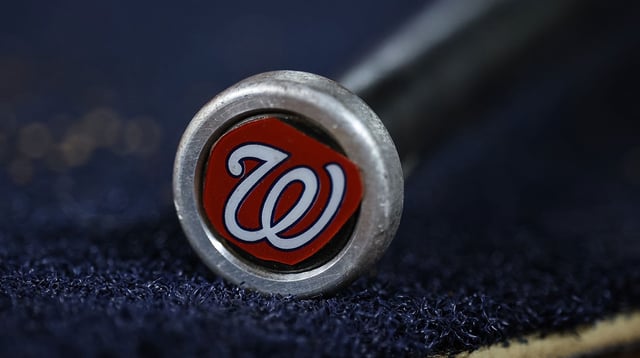 May 12, 2023; Washington, District of Columbia, USA; A detailed view of the Washington Nationals logo on a weighted bat during the seventh inning of the game between the Washington Nationals and the New York Mets at Nationals Park. Mandatory Credit: Scott Taetsch-Imagn Images