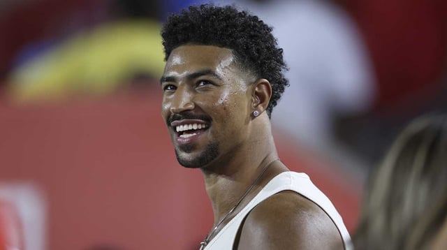 76ers player Quentin Grimes smiles while watching the game between the Houston Cougars and the Colorado Buffaloes at TDECU Stadium