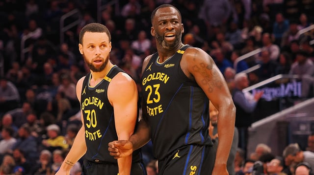 Feb 3, 2025; San Francisco, California, USA; Golden State Warriors guard Stephen Curry (30) and forward Draymond Green (23) look towards an Orlando Magic player at half time at Chase Center. Mandatory Credit: Kelley L Cox-Imagn Images