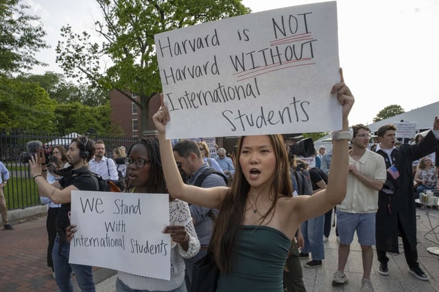 People hold up signs during the Harvard Students for Freedom rally in support of international students at the Harvard University campus in Boston, Massachusetts, on May 27, 2025. Harvard students protested after the U.S. government said it intends to cancel all remaining financial contracts with the university, President Donald Trump's latest attempt to force the prestigious institution to submit to unprecedented...