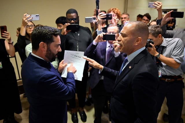 Rep. Michael Lawler, R-N.Y., left, confronts House Minority Leader Hakeem Jeffries, D-N.Y., in a heated discussion to endorse House bill H.R.5145 that would extend the American Rescue Plan Act of 2021 and the Inflation Reduction Act of 2022 at the U.S. Capitol on Wednesday, Oct. 8, 2025, in Washington. (AP Photo/John McDonnell)