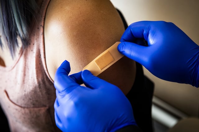 A patient is bandaged after a Covid-19 vaccine at Boston Medical Center, in Boston, on June 17, 2021.