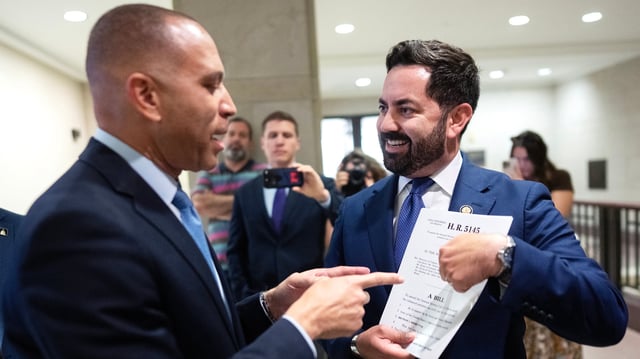 Rep. Mike Lawler, R-N.Y.,  right, confronts House Minority Leader Hakeem Jeffries, D-N.Y., about signing on to a bill that would extend Affordable Care Act tax credits, after a House Democrats news conference in the Capitol Visitor Center on on Oct. 8, 2025.
