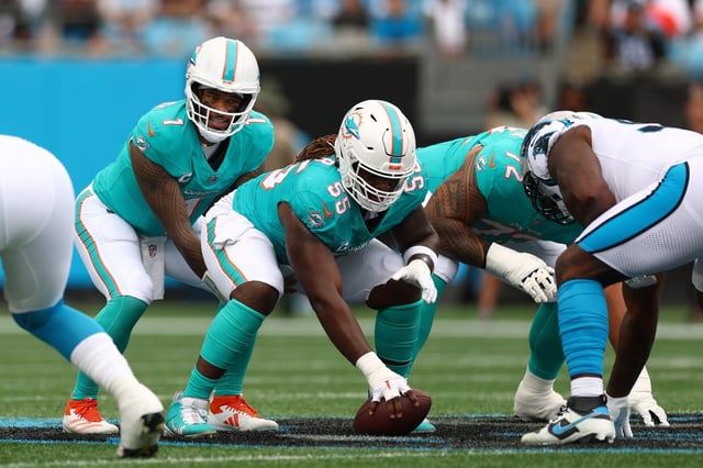 Tua Tagovailoa #1 and Aaron Brewer #55 of the Miami Dolphins lines up during the first quarter against the Carolina Panthers in the game at Bank of America Stadium on Oct. 05, 2025 in Charlotte, North Carolina. (Photo by Grant Halverson/Getty Images)