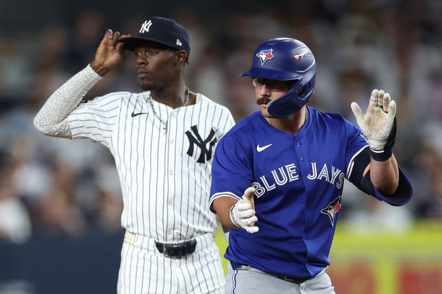 NEW YORK, NEW YORK - OCTOBER 07: Davis Schneider #36 of the Toronto Blue Jays reacts after a double in front of Jazz Chisholm Jr. #13 of the New York Yankees during the third inning in game three of the American League Division Series at Yankee Stadium on October 07, 2025 in the Bronx borough of New York City. (Photo by Ishika Samant/Getty Images)