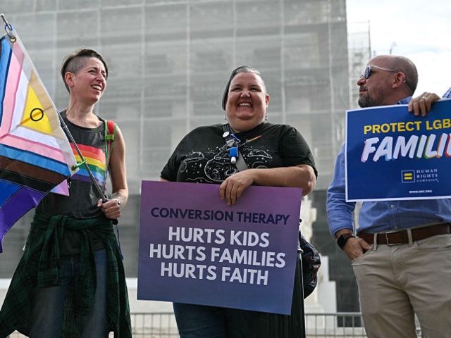 Demonstrators protest against conversion therapy outside the US Supreme Court as the Court hears oral arguements in Chiles v. Salazar, a landmark case on conversion therapy, on October 7, 2025, in Washington, DC. The Supreme Court will hear a challenge today by a Christian therapist to a Colorado law that bans "conversion therapy" for minors who are questioning their gender identity or sexual orientation. The case was brought by Kaley Chiles, a licensed mental health counselor who argues that the prohibition from holding such conversations with minors is a violation of her First Amendment free speech rights. (Photo by ANDREW CABALLERO-REYNOLDS / AFP) (Photo by ANDREW CABALLERO-REYNOLDS/AFP via Getty Images)