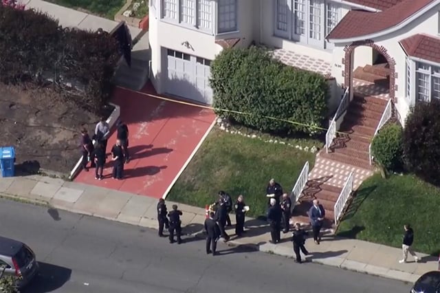 Investigators stand outside a home where four people were found dead in San Francisco, on Oct. 10, 2025.