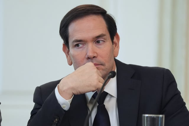 Secretary of State Marco Rubio listens before interrupting President Donald Trump during a roundtable meeting on antifa in the State Dining Room at the White House, Wednesday, Oct. 8, 2025, in Washington. (AP Photo/Evan Vucci)