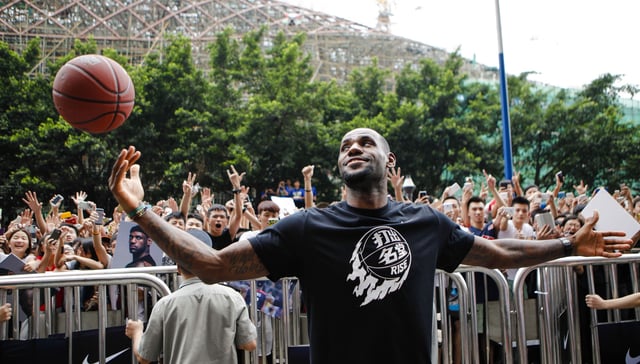 LeBron James plays with a basketball during a promotional event at a store in Guangzhou, China in July, 2014.