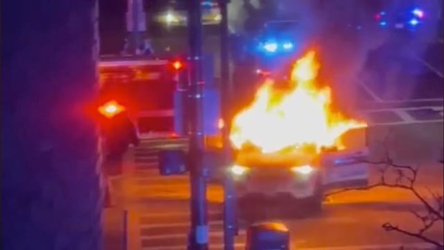 A Boston Police cruiser on fire at the intersection of Massachusetts Avenue and Tremont Street.