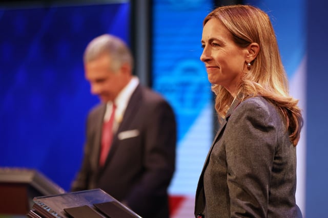 Democrat Mikie Sherrill, right, waits during a break at the final debate in the New Jersey governor's race with Republican Jack Ciattarelli on Wednesday, Oct. 8, 2025, in New Brunswick, New Jersey.