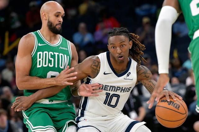 Memphis Grizzlies guard Javon Small (10) handles the ball against Boston Celtics guard Derrick White in the first half of an NBA basketball preseason game Wednesday, Oct. 8, 2025, in Memphis, Tenn. (AP Photo/Brandon Dill)