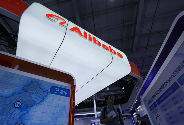 A man walks next to the Alibaba booth with the company logo at China International Fair for Trade in Services (CIFTIS) in Beijing, China, September 10, 2025. REUTERS/Maxim Shemetov