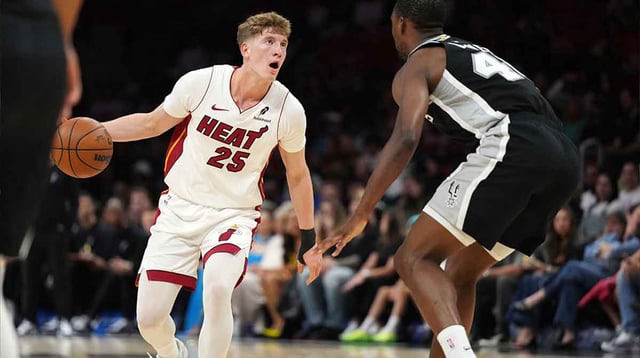 Oct 8, 2025; Miami, Florida, USA; Miami Heat guard Kasparas Jakucionis (25) looks to pass the ball as San Antonio Spurs forward Harrison Barnes (40) defends in the first half at Kaseya Center. Mandatory Credit: Jim Rassol-Imagn Images