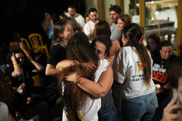 Relatives and supporters of Israeli hostages held by Hamas in the Gaza Strip celebrate after the announcement that Israel and Hamas have agreed to the first phase of a peace plan, as they gather at a plaza known as the hostages square in Tel Aviv, Israel, Thursday, Oct. 9, 2025. (AP Photo/Emilio Morenatti)