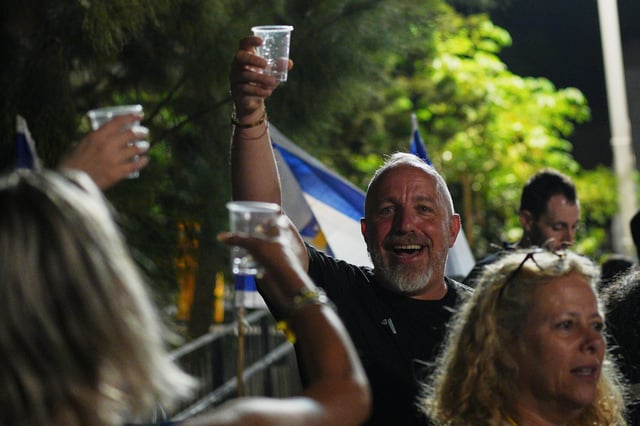 Relatives and supporters of Israeli hostages held by Hamas in the Gaza Strip celebrate after the announcement that Israel and Hamas have agreed to the first phase of a peace plan, as they gather at a plaza known as the hostages square in Tel Aviv, Israel, Thursday, Oct. 9, 2025. (AP Photo/Emilio Morenatti)