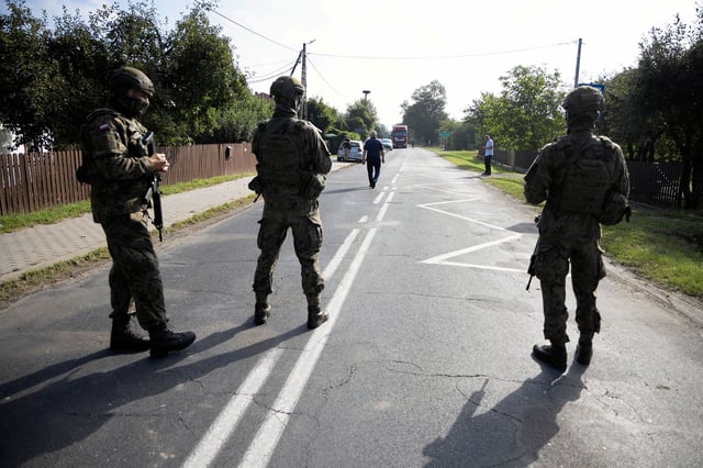 Soldiers patrol the street after a drone struck a residential building, following violations of Polish airspace during a Russian attack on Ukraine, in Wyryki municipality, Poland, on September 10, 2025.