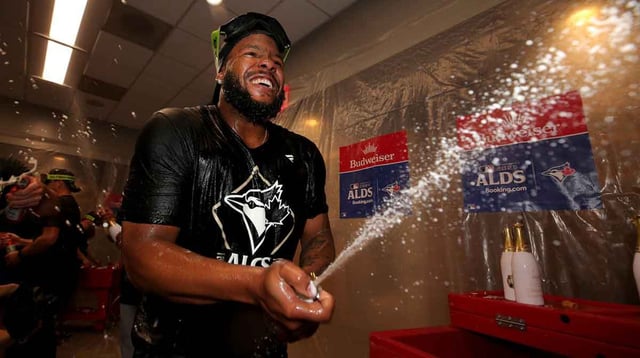 Oct 8, 2025; Bronx, New York, USA; Toronto Blue Jays first baseman Vladimir Guerrero Jr. (27)celebrates in the locker room after defeating the New York Yankees in game four of the ALDS round of the 2025 MLB playoffs at Yankee Stadium. Mandatory Credit: Brad Penner-Imagn Images