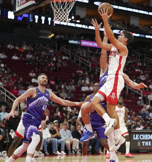 Houston Rockets guard Reed Sheppard (15) goes up for a shot during the second half of a preseason NBA basketball game in Houston, Wednesday, Oct. 8, 2025.
