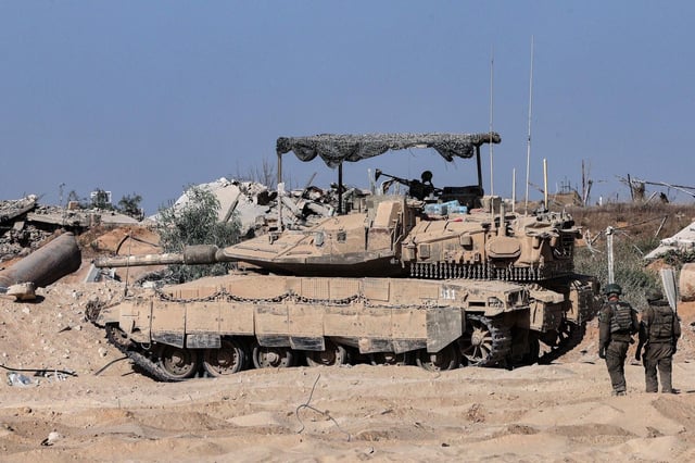 This picture taken during a media tour organised by the Israeli army shows Israeli army soldiers walking toward a armoured military vehicle at a position in the vicinity of the Jordanian Field Hospital in Gaza City, Friday, Oct. 3, 2025. (Jack Guez/Pool Photo via AP) Associated Press/LaPresse. EDITORIAL USE ONLY/ONLY ITALY AND SPAIN