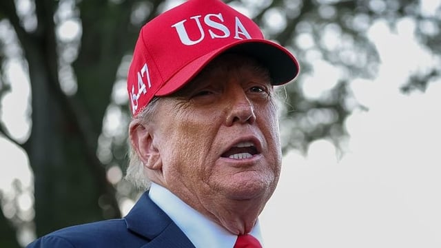 U.S. President Donald Trump talks to the media after walking off Marine One on the South Lawn of the White House on October 05, 2025 in Washington, DC. Trump was returning from a celebration of the Navy’s 250th anniversary in Norfolk, Virginia.