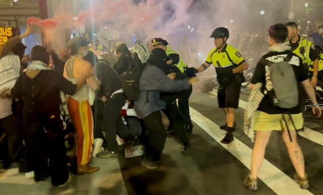 Boston police attempt to clear Tremont Street as protesters burn smoke flares in Boston Tuesday night. (Photo by Cooper Formica/Special to the Boston Herald)