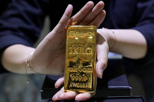 A staff member shows a one-kilogram gold bar at the Galeri 24 gold and jewellery shop in Jakarta, Indonesia, October 9, 2025. REUTERS/Ajeng Dinar Ulfiana