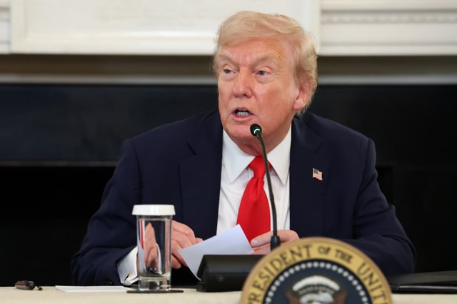 WASHINGTON, DC - OCTOBER 08: U.S. President Donald Trump reads a note handed to him by U.S. Secretary of State Marco Rubio he said was regarding Middle East peace talks during a roundtable discussion in the State Dining Room of the White House on October 08, 2025 in Washington, DC. Trump’s administration held the roundtable to discuss the anti-fascist Antifa movement after signing an executive order designating it as a “domestic terrorist organization”. (Photo by Anna Moneymaker/Getty Images)
