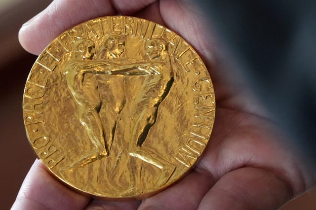 An employee of the Norwegian Nobel Institute holds a replica of a Nobel Peace Medal in the Institute in Oslo, Norway, on Sept. 9, 2025.