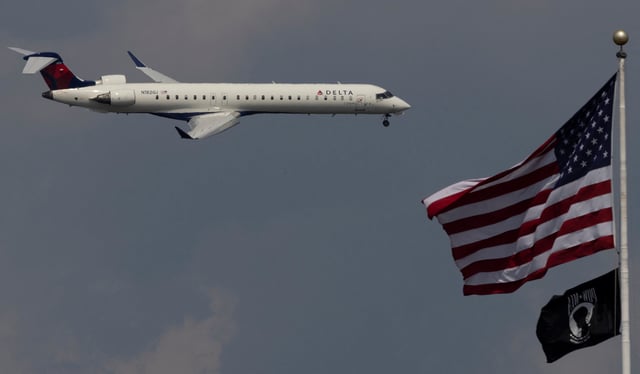 A Delta Airlines commercial aircraft flies over Washington as it approaches to land at Dulles International Airport, as seen from Washington, U.S., August 5, 2024. REUTERS/ Umit Bektas