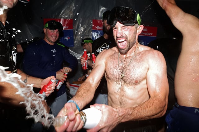 The Blue Jays celebrate wildly in the locker room after victory.