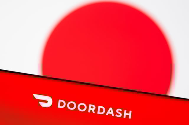 Doordash logo is seen on a smartphone in front of displayed Japan flag in this illustration picture taken June 9, 2021. REUTERS/Dado Ruvic/Illustration