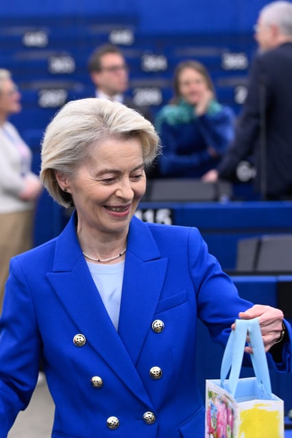 European Commission president Ursula von der Leyen holds a gift she got for her birthday before delivering her statement on EU response to recent Russian violations of the EU Member States' airspace and critical infrastructure, Wednesday, Oct. 8, 2025 at the European Parliament in Strasbourg, eastern France. (AP Photo/Pascal Bastien)