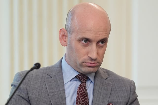 White House deputy chief of staff Stephen Miller listens as President Donald Trump speaks during a roundtable meeting on antifa in the State Dining Room at the White House, Wednesday, Oct. 8, 2025, in Washington. (AP Photo/Evan Vucci)