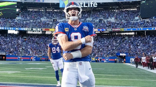 Nov 3, 2024; East Rutherford, New Jersey, USA; New York Giants quarterback Daniel Jones (8) celebrates after scoring a 2nd half touchdown against the Washington Commanders at MetLife Stadium. Mandatory Credit: Robert Deutsch-Imagn Images.