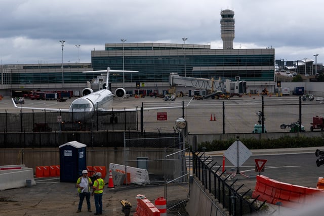 Construction crews work near the air traffic control tower at Reagan Washington National Airport as the U.S. government shutdown continues in Arlington, Virginia, U.S., October 8, 2025. REUTERS/Nathan Howard