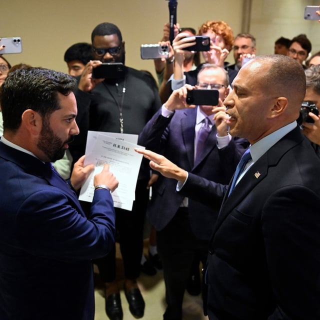 Rep. Michael Lawler, R-N.Y., left, confronts House Minority Leader Hakeem Jeffries, D-N.Y., in a heated discussion to endorse House bill H.R.5145 that would extend the American Rescue Plan Act of 2021 (ARPA) and the Inflation Reduction Act of 2022 at the U.S. Capitol on Wednesday, Oct. 8, 2025, in Washington. (AP Photo/John McDonnell)