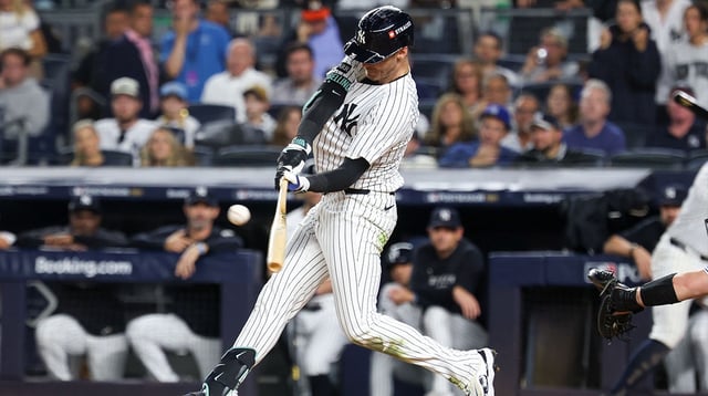 Oct 7, 2025; Bronx, New York, USA; New York Yankees outfielder Cody Bellinger (35) hits a double in the sixth inning against the Toronto Blue Jays during game three of the ALDS round for the 2025 MLB playoffs at Yankee Stadium. Mandatory Credit: Vincent Carchietta-Imagn Images