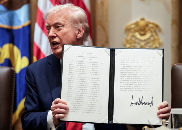 President Donald Trump holds an executive order about Columbus Day during a cabinet meeting at the White House in Washington, D.C., U.S., October 9, 2025.