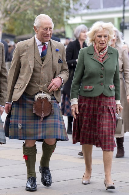 Britain's King Charles and Queen Camilla walk during a visit to mark the 150th anniversary of the Albert Hall in Ballater, Scotland, Britain, October 9, 2025.   Jane Barlow/Pool via REUTERS