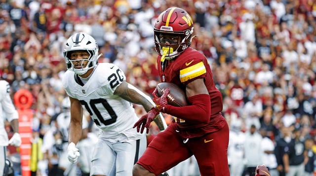 Sep 21, 2025; Landover, Maryland, USA; Washington Commanders wide receiver Terry McLaurin (17) runs the ball during the second half as Las Vegas Raiders safety Isaiah Pola-Mao (20) defends at Northwest Stadium. Mandatory Credit: Amber Searls-Imagn Images