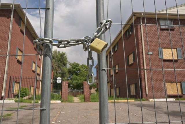 The Edge of Lowry apartment complex is fenced off, with most windows and doors boarded up, in Aurora on Aug. 7, 2025. (Photo by RJ Sangosti/The Denver Post)