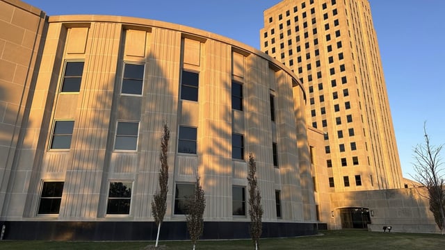 Sunlight illuminates the exterior of the North Dakota House of Representatives and the state Capitol tower in Bismarck, N.D., on Friday, Nov. 10, 2023. A federal judge ruled on Friday, Nov. 17, that North Dakota’s 2021 redistricting plan for state legislative districts violates the Voting Rights Act for how the Legislature reapportioned districts comprising two tribal nations. The Turtle Mountain Band of Chippewa Indians and the Spirit Lake Tribe filed their lawsuit last year, which went to trial in June 2023, resulting in the Nov. 17 ruling. (AP Photo/Jack Dura)