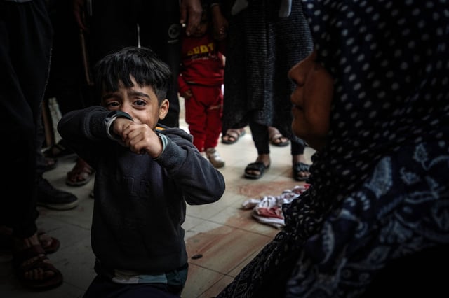 A child cries as people mourn loved ones killed during Israeli bombardment at Nasser Hospital in Khan Younis, southern Gaza on Wednesday. Photo: AFP / Getty Images / TNS