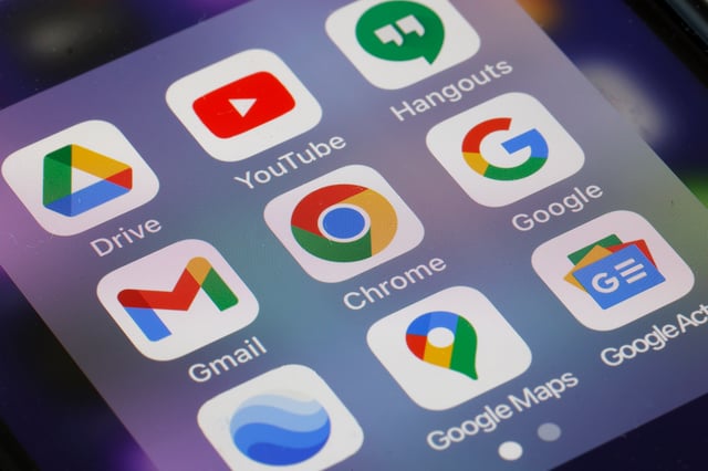 Google app logos, Drive, YouTube, Gmail, Chrome, Google and Google Maps are displayed on the screen of an iPhone