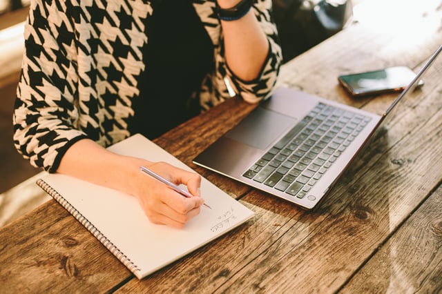 A woman working on her laptop.